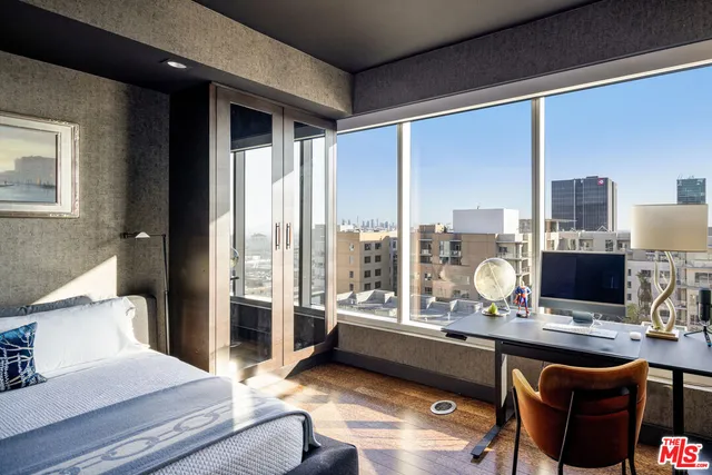 a living room with furniture and a floor to ceiling window