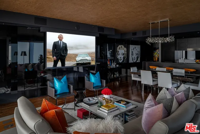 a living room with furniture and a floor to ceiling window