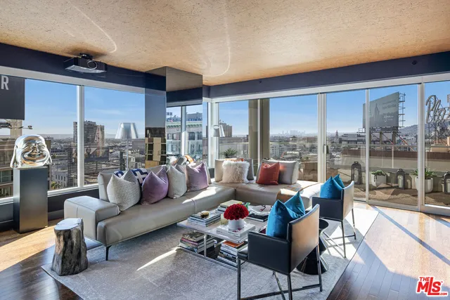 a living room with furniture and a floor to ceiling window