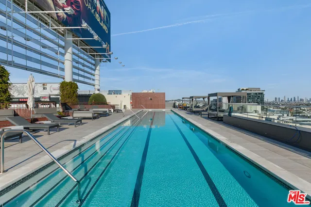 a balcony with view of residential houses with outdoor space