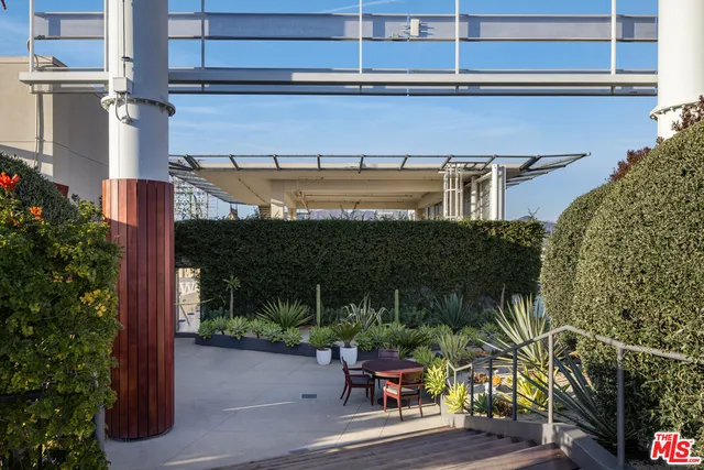 a view of a patio with table and chairs potted plants