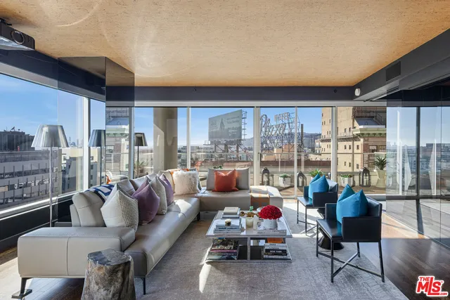 a living room with furniture and a floor to ceiling window