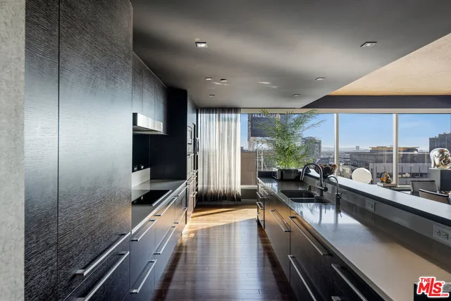 a large white kitchen with a large window