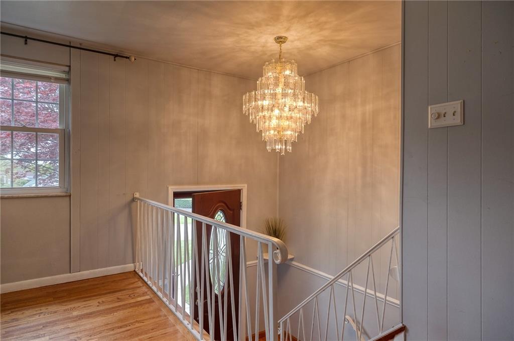 732 Charles Street Rochester, PA 15074 - Photo 16 of 38 a view of a hallway with windows and chandelier