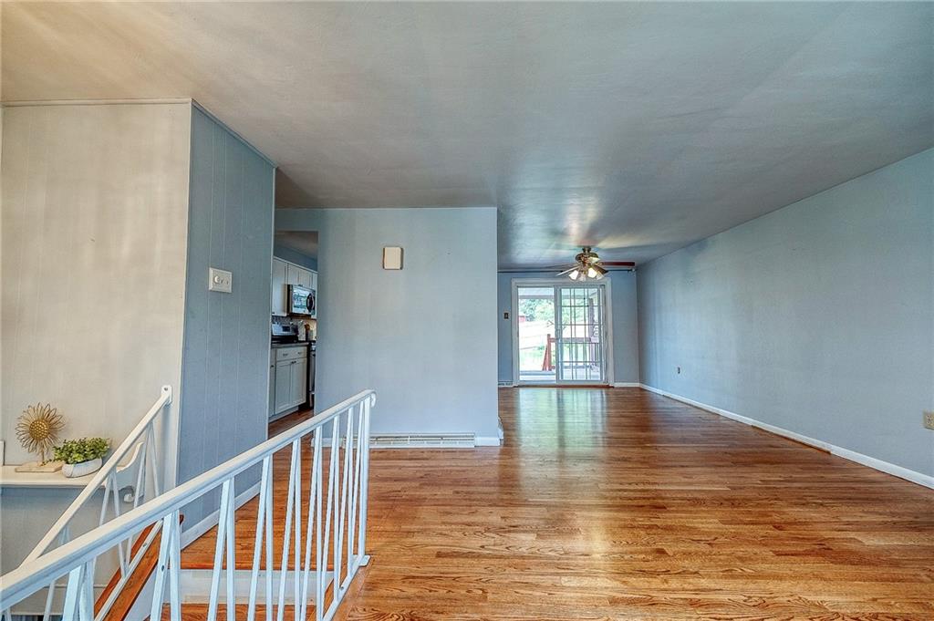 732 Charles Street Rochester, PA 15074 - Photo 18 of 38 a view of empty room with wooden floor and fan