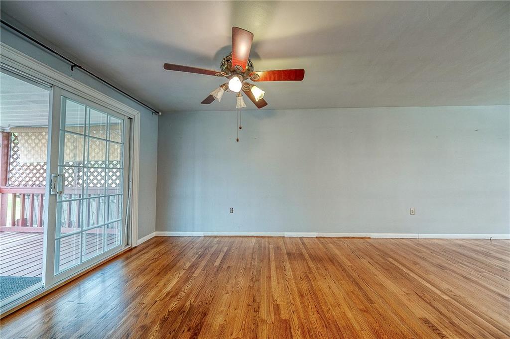 732 Charles Street Rochester, PA 15074 - Photo 21 of 38 an empty room with wooden floor fan and windows