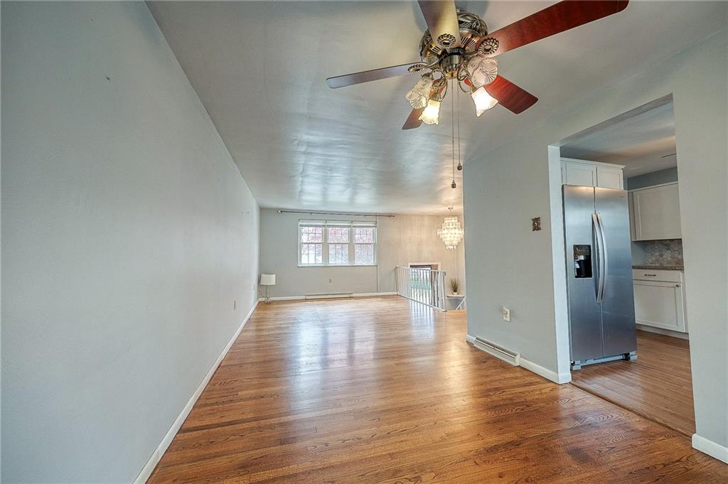 732 Charles Street Rochester, PA 15074 - Photo 22 of 38 a view of an empty room with window and wooden floor