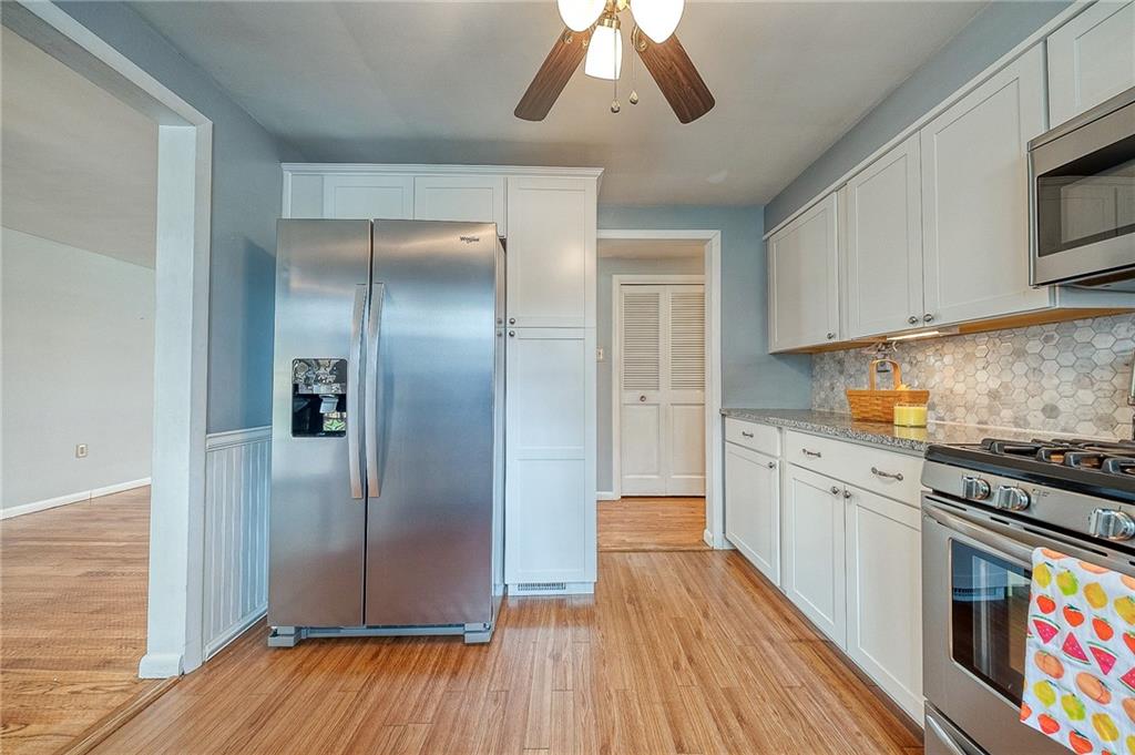 732 Charles Street Rochester, PA 15074 - Photo 25 of 38 a kitchen with stainless steel appliances a refrigerator and a stove top oven
