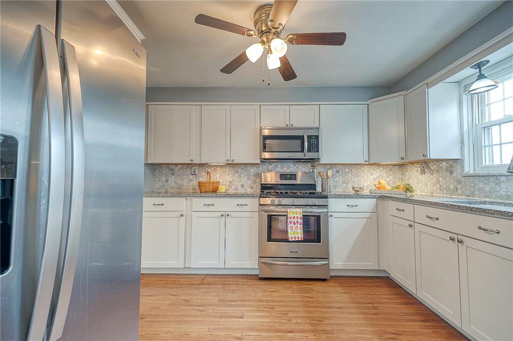732 Charles Street Rochester, PA 15074 - Photo 26 of 38 a kitchen with stainless steel appliances granite countertop a stove a sink and a refrigerator