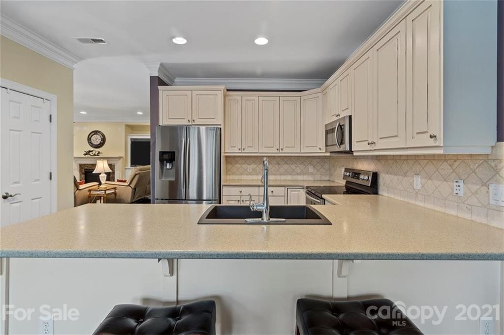 302 Shinnecock Lane Fort Mill, SC 29708 - Photo 15 of 36 a kitchen with stainless steel appliances granite countertop a sink a stove and a refrigerator