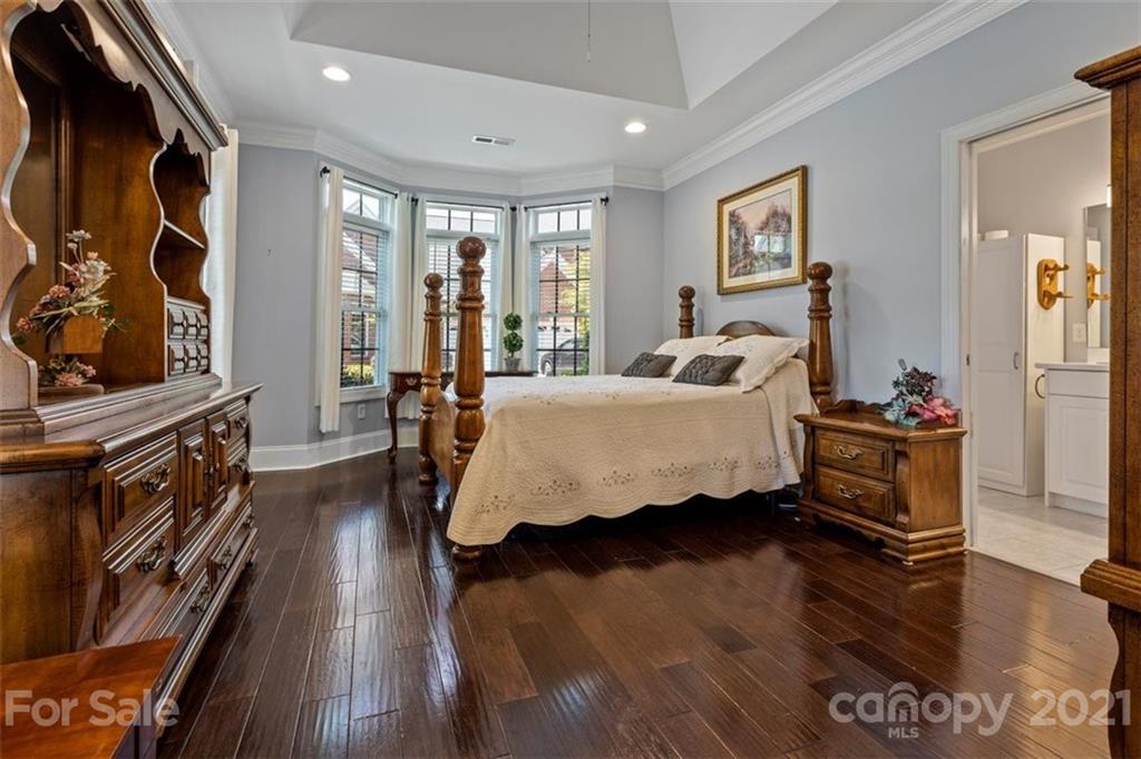 302 Shinnecock Lane Fort Mill, SC 29708 - Photo 21 of 36 a bedroom with furniture window and wooden floor