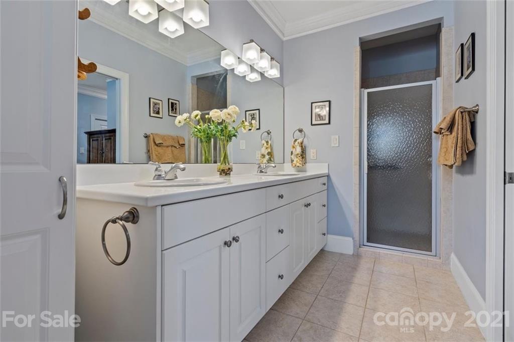 302 Shinnecock Lane Fort Mill, SC 29708 - Photo 23 of 36 a spacious bathroom with a granite countertop sink a light fixture and a mirror