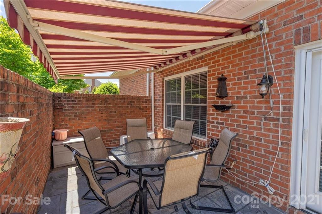 302 Shinnecock Lane Fort Mill, SC 29708 - Photo 28 of 36 a patio with table and chairs and potted plants