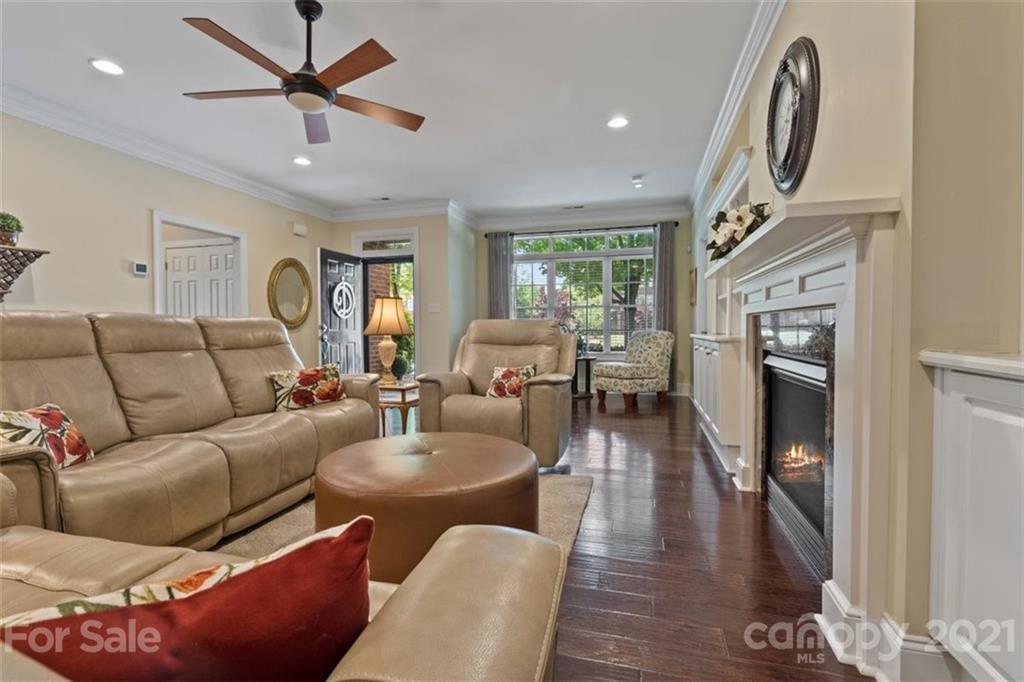 302 Shinnecock Lane Fort Mill, SC 29708 - Photo 6 of 36 a living room with furniture a fireplace and a chandelier