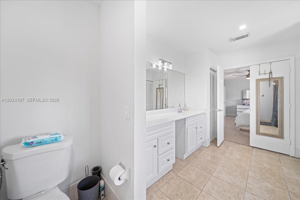 15341 Southwest 36th Street Miami, FL 33185 - Photo 22 of 56 a spacious bathroom with a granite countertop sink a mirror and a bathtub