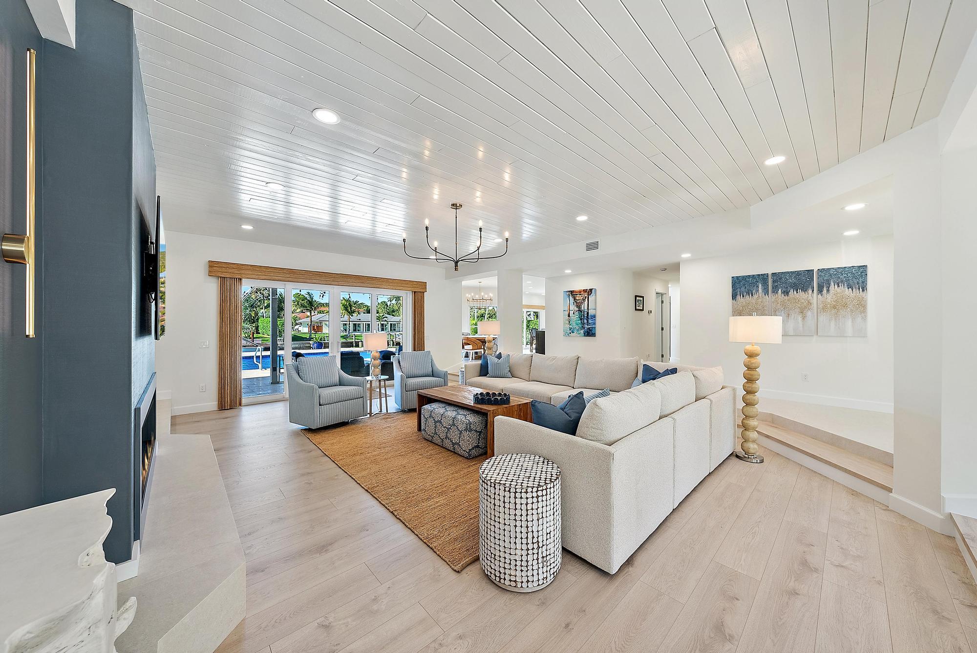 19 Island Road Sewall's Point, FL 34996 - Photo 8 of 50 a living room with furniture and a chandelier