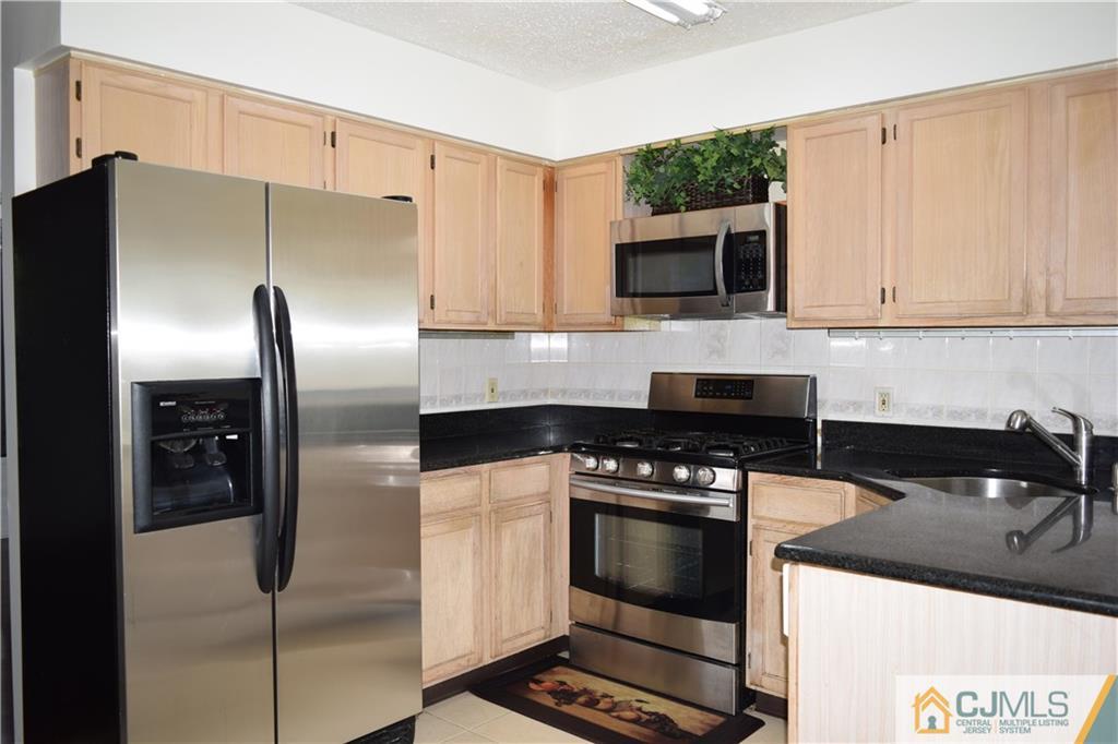 350 Lunar Road Piscataway, NJ 08854 - Photo 2 of 19 a kitchen with stainless steel appliances granite countertop a stove a refrigerator and a sink