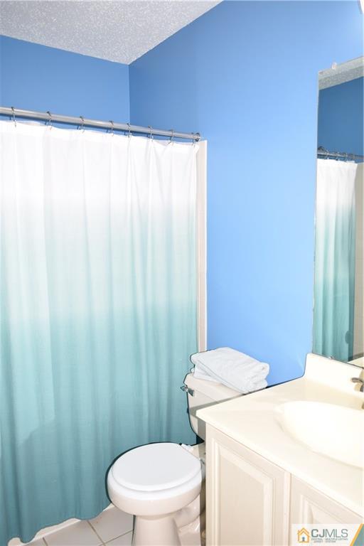 350 Lunar Road Piscataway, NJ 08854 - Photo 12 of 19 a white toilet sitting next to a shower curtain