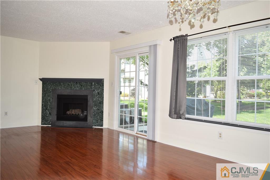 350 Lunar Road Piscataway, NJ 08854 - Photo 4 of 19 a view of an empty room with wooden floor and a window