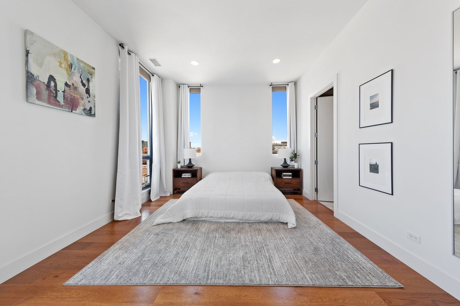 122 South Aberdeen Street, Unit 5N Chicago, IL 60607 - Photo 12 of 23 a spacious bedroom with a large bed and a chandelier