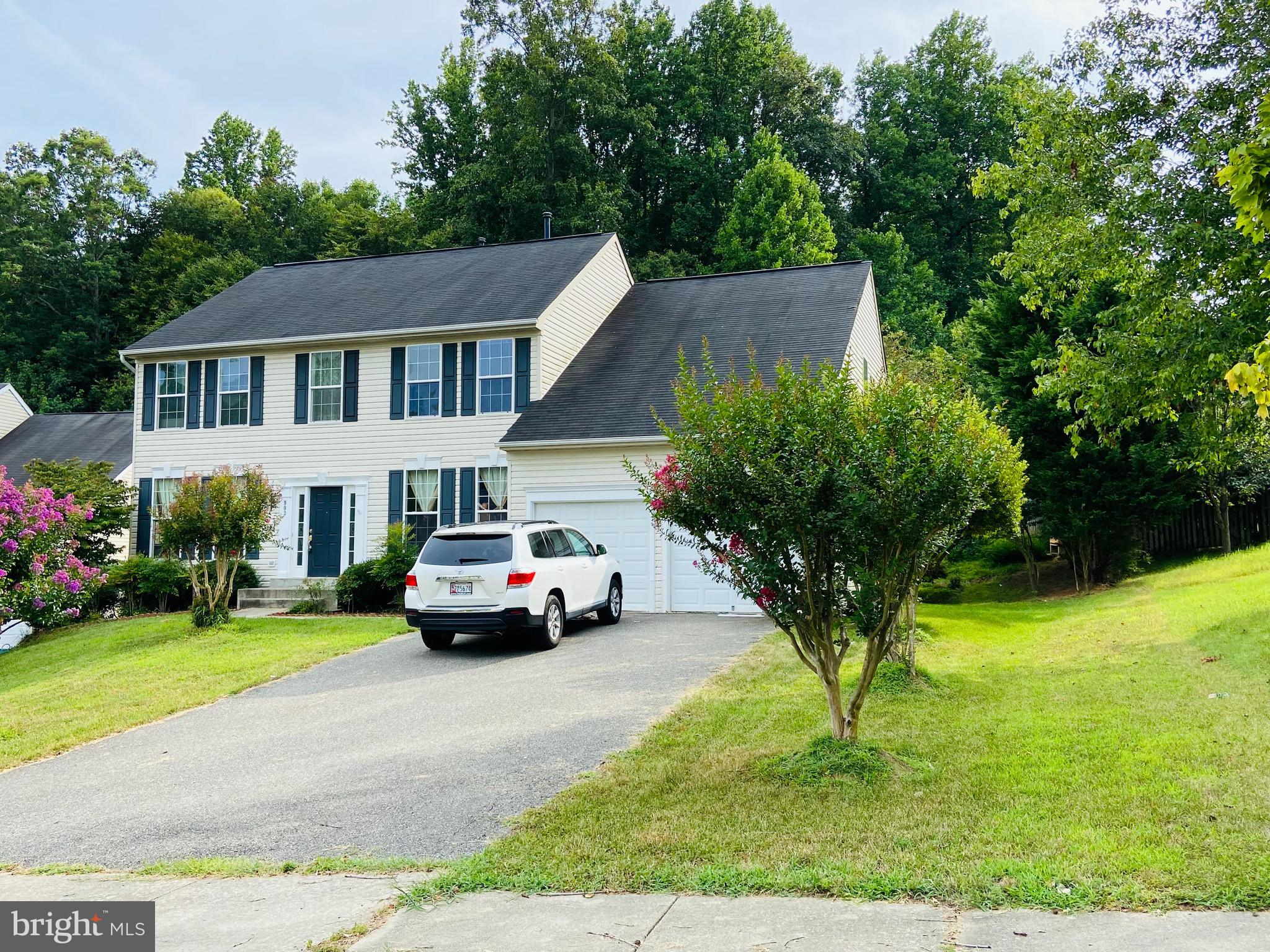 903 Johnson Grove Lane Bowie, MD 20721 - Photo 1 of 11 a car parked in front of a house with potted plants