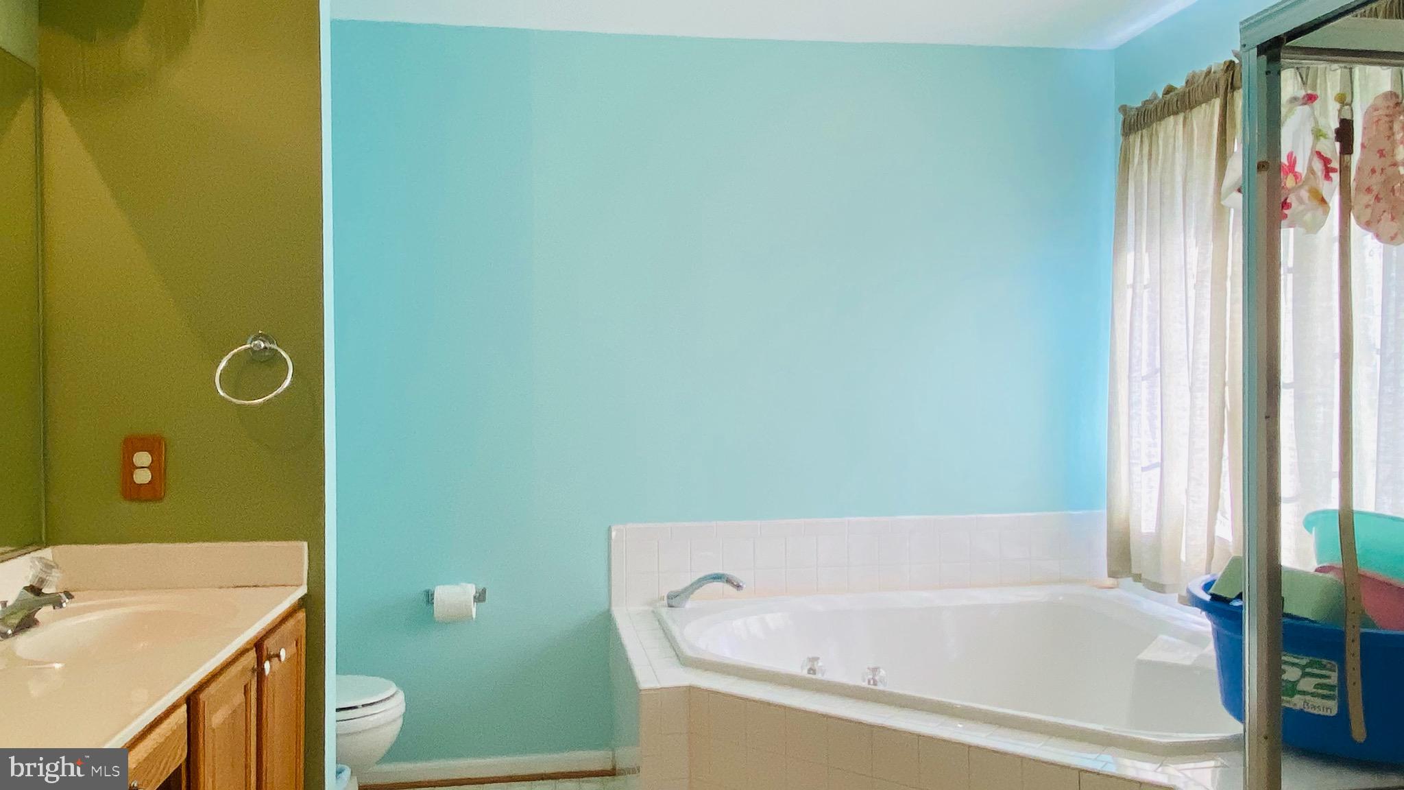 903 Johnson Grove Lane Bowie, MD 20721 - Photo 8 of 11 a bathroom with a tub sink and toilet