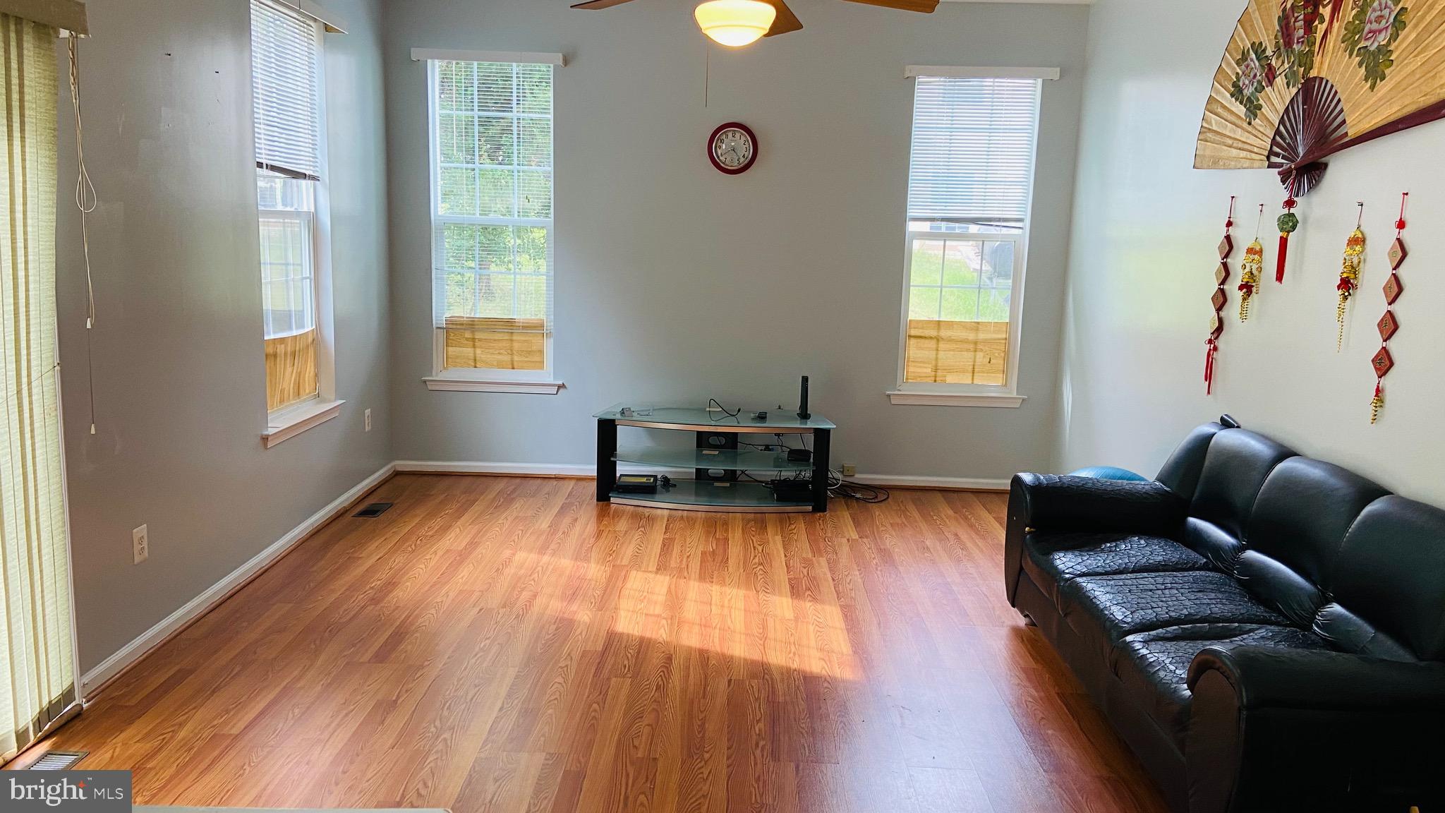 903 Johnson Grove Lane Bowie, MD 20721 - Photo 9 of 11 a living room with furniture and a wooden floor
