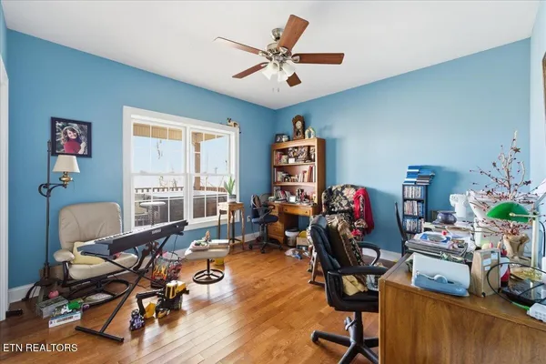 a view of a workspace with furniture and a window