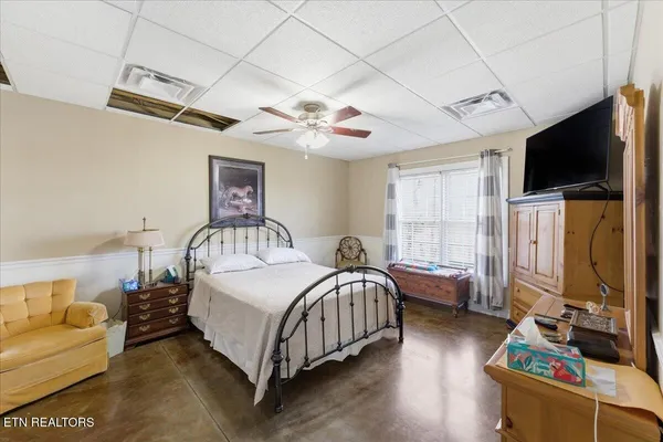 a bedroom with bed and a flat screen tv