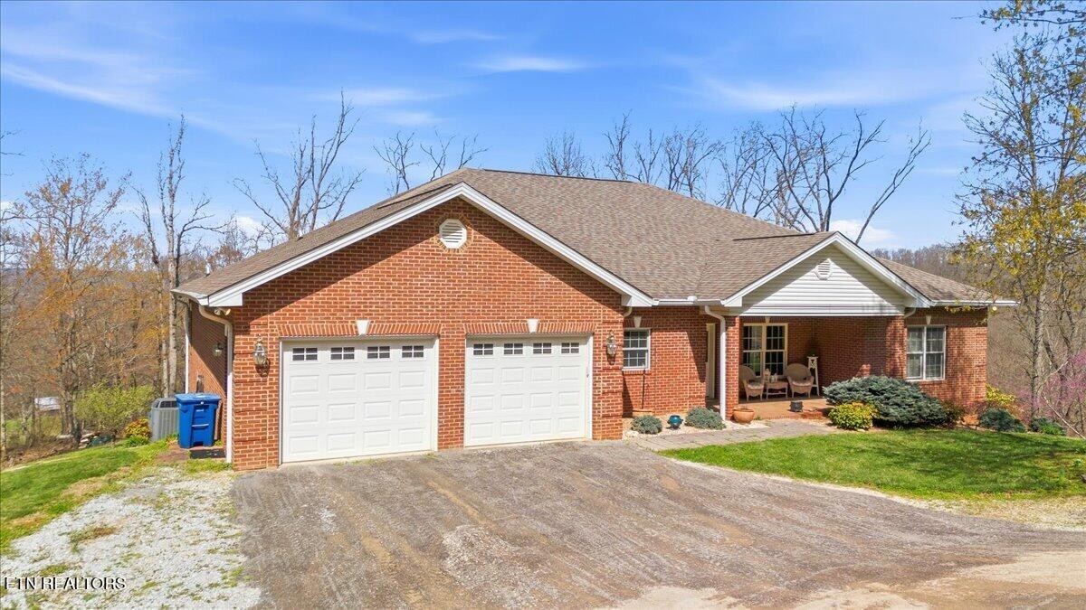 1999 Repass Road New Market, TN 37820 - Photo 4 of 52 a front view of a house with a yard and garage