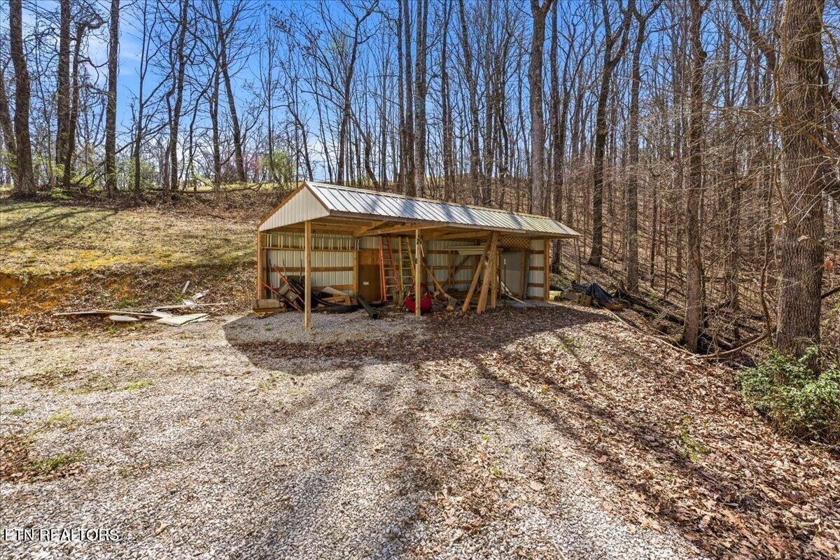 1999 Repass Road New Market, TN 37820 - Photo 43 of 52 a backyard of a house with barbeque oven table and chairs