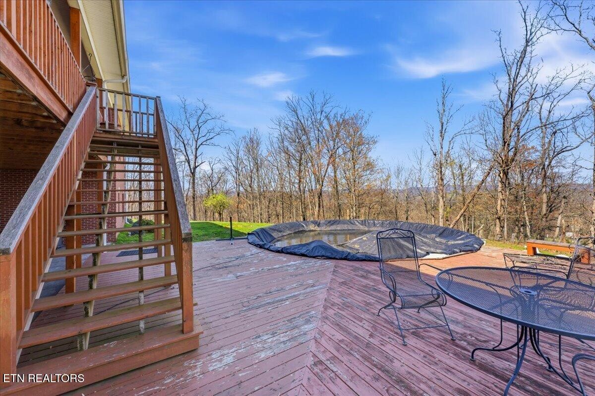 1999 Repass Road New Market, TN 37820 - Photo 46 of 52 a backyard of a house with table and chairs