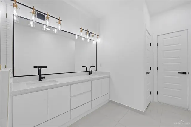 a bathroom with a sink and mirror