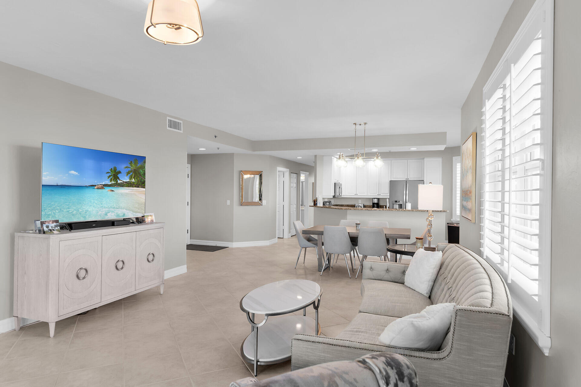 1111 Swallow Avenue, Unit 1401 Marco Island, FL 34145 - Photo 30 of 36 a living room with furniture and a flat screen tv