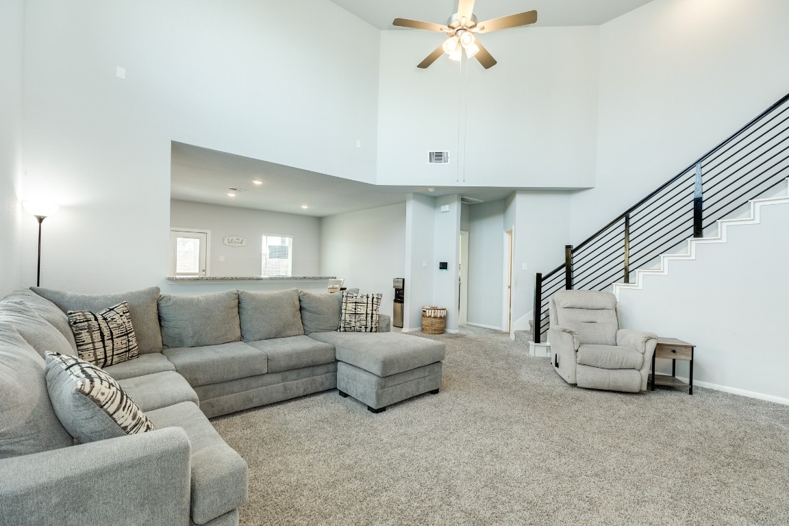 3640 Crosspointe Pass Angleton, TX 77515 - Photo 15 of 21 a living room with furniture and a chandelier
