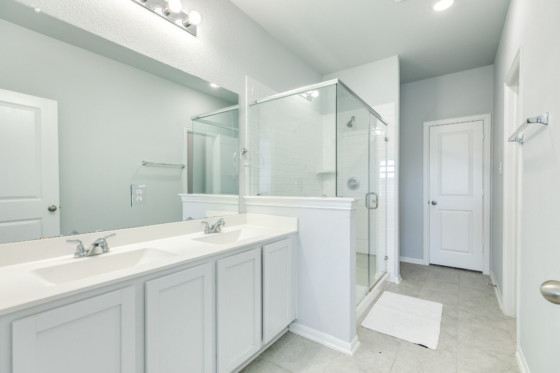 3640 Crosspointe Pass Angleton, TX 77515 - Photo 7 of 21 a bathroom with a double vanity sink mirror and double