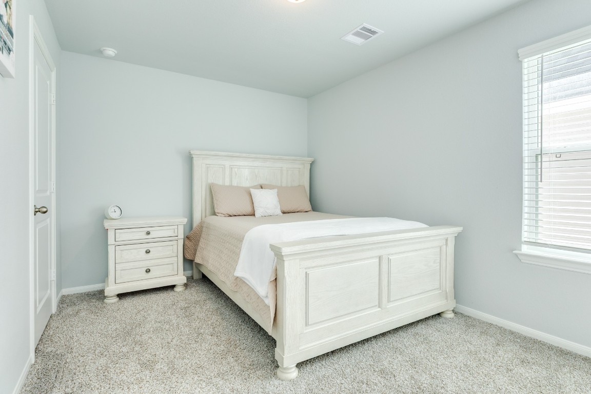 3640 Crosspointe Pass Angleton, TX 77515 - Photo 8 of 21 a view of a bedroom with white bed and window
