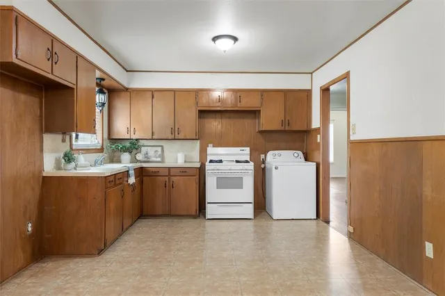 a kitchen with a stove top oven sink and cabinets