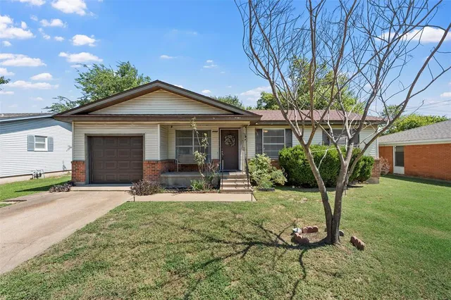 a front view of a house with yard outdoor seating and barbeque oven