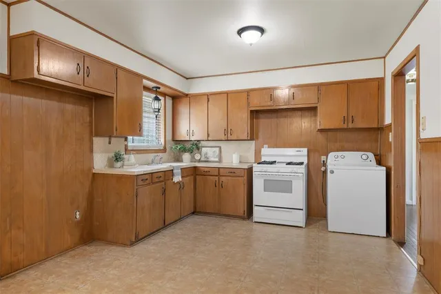 a kitchen with sink a window and stainless steel appliances
