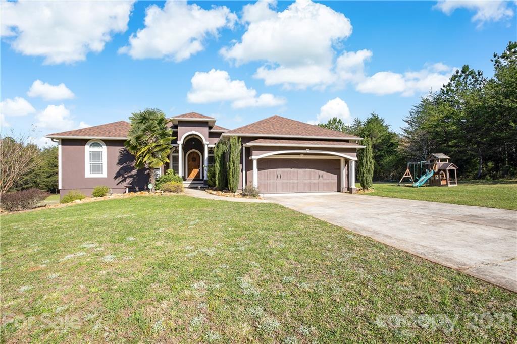 295 Brians Way Rutherfordton, NC 28139 - Photo 2 of 38 a front view of a house with a garden and yard