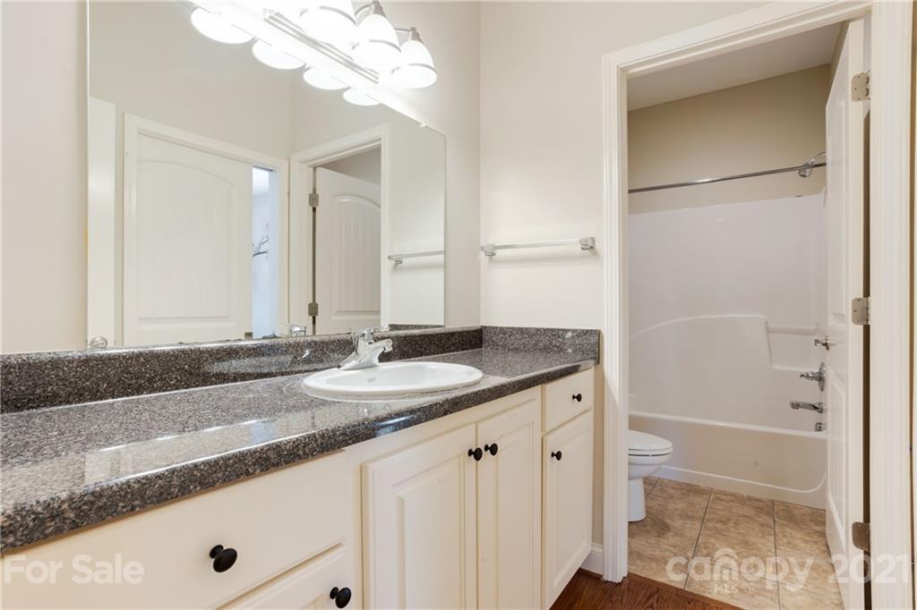 295 Brians Way Rutherfordton, NC 28139 - Photo 13 of 38 a bathroom with a granite countertop sink and a mirror