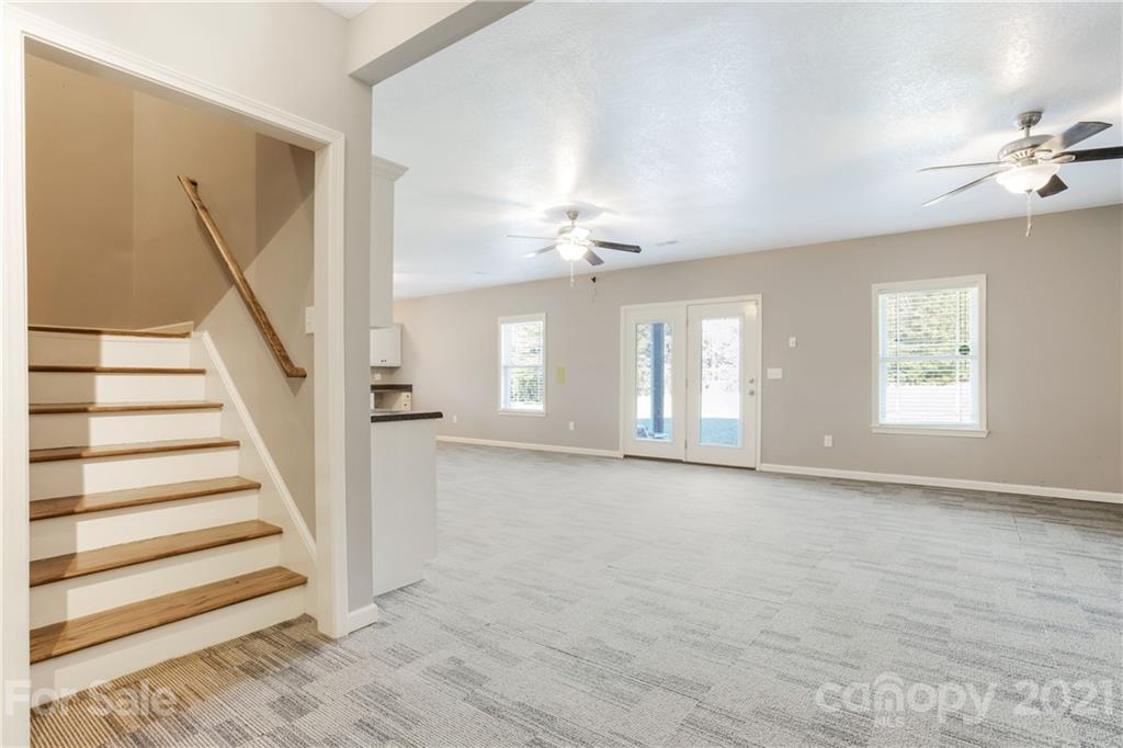 295 Brians Way Rutherfordton, NC 28139 - Photo 21 of 38 a view of an empty room with wooden floor and a window