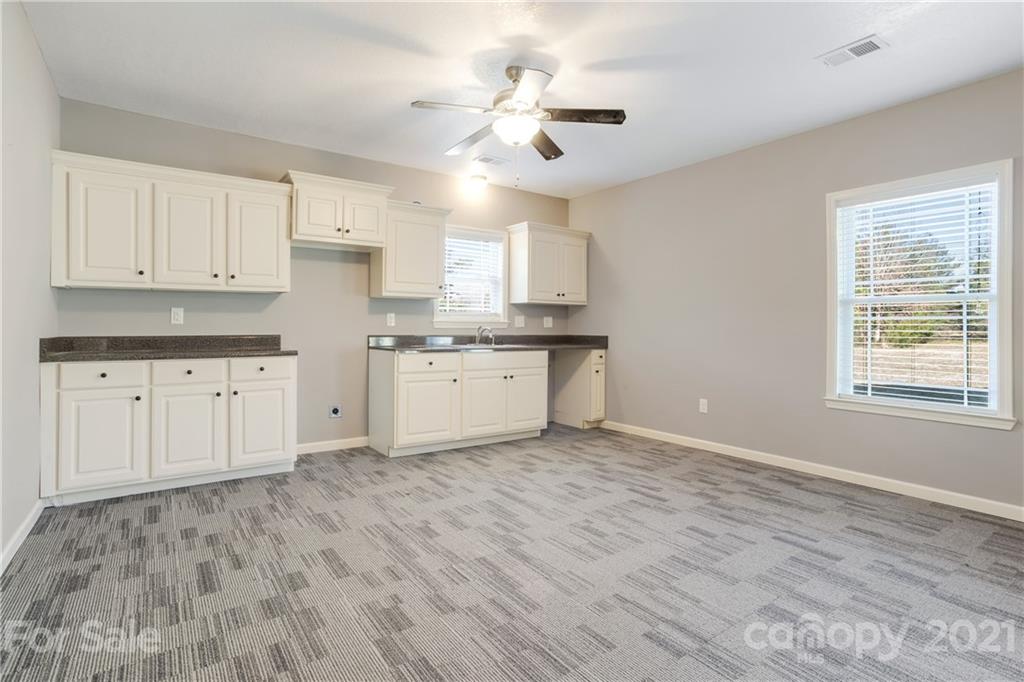 295 Brians Way Rutherfordton, NC 28139 - Photo 25 of 38 a view of kitchen with granite countertop cabinets and wooden floor