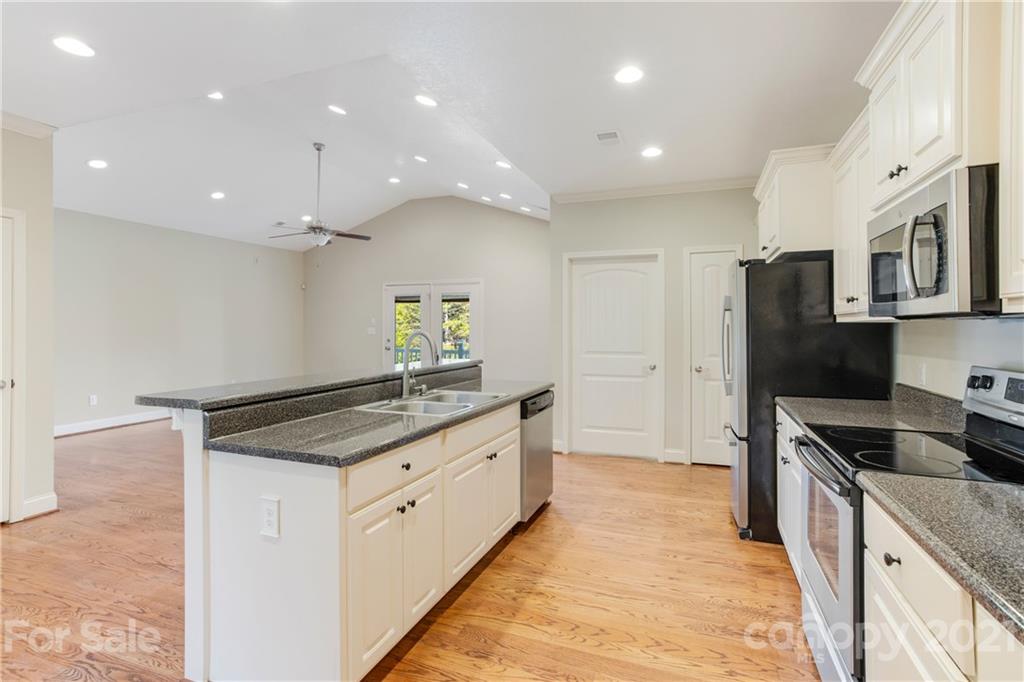 295 Brians Way Rutherfordton, NC 28139 - Photo 7 of 38 a kitchen with stainless steel appliances granite countertop a sink a stove and a refrigerator