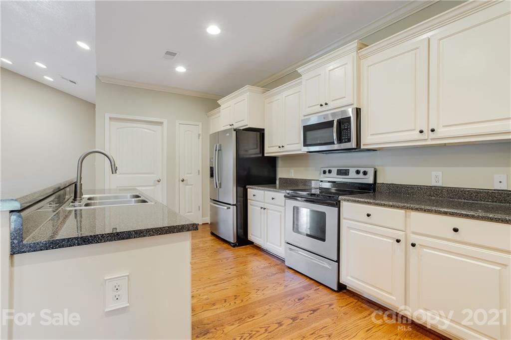 295 Brians Way Rutherfordton, NC 28139 - Photo 8 of 38 a kitchen with stainless steel appliances granite countertop a stove a sink and a microwave
