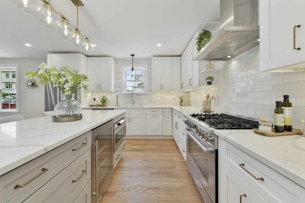 a kitchen with kitchen island a sink stove and cabinets