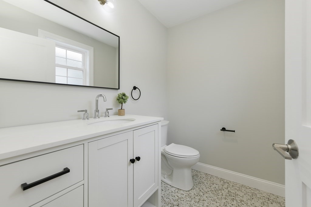 25 Locust Street, Unit 1 Winthrop, MA 02152 - Photo 12 of 38 a bathroom with a sink toilet and mirror