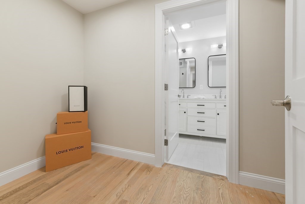 25 Locust Street, Unit 1 Winthrop, MA 02152 - Photo 15 of 38 wooden floor and mirror in a room