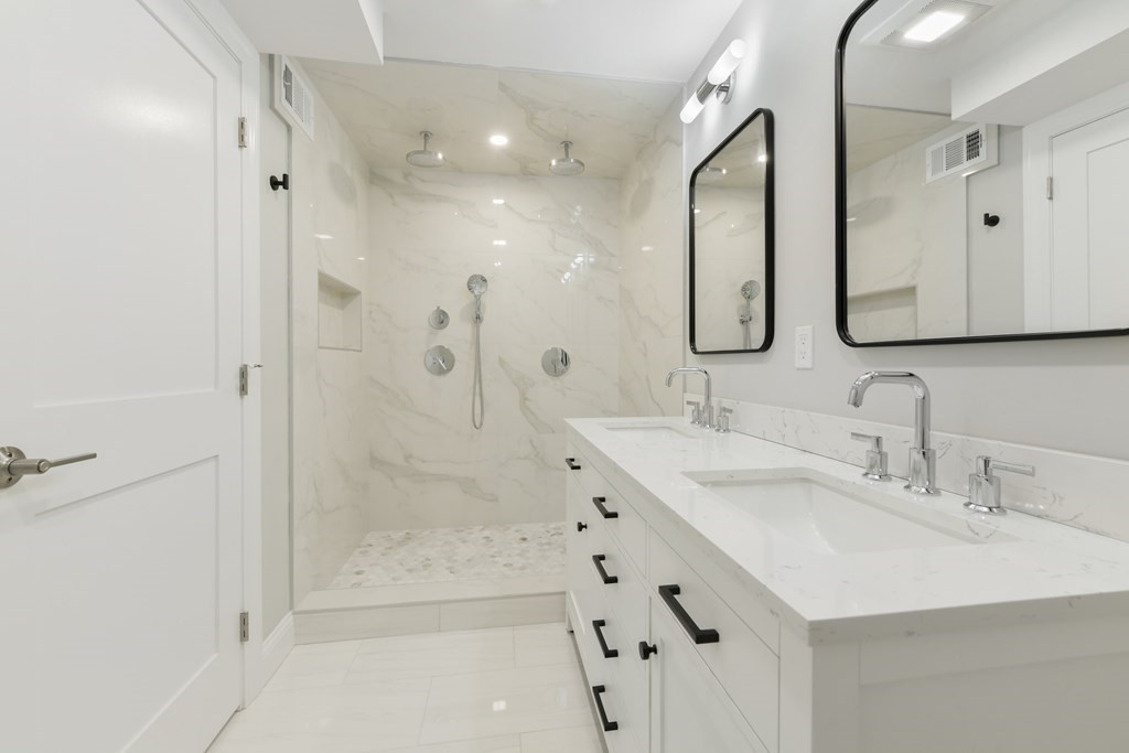 25 Locust Street, Unit 1 Winthrop, MA 02152 - Photo 16 of 38 a bathroom with a double vanity sink mirror and shower